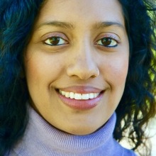 Close-up of Samhita Sunya smiling warmly at the camera.