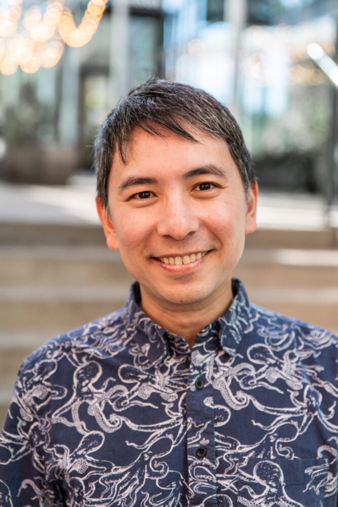 Steven J. Kung smiling in a blue octopus-patterned shirt.