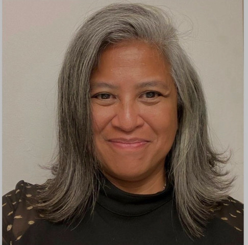 Genevieve Villaflor, headshot of a smiling woman with gray hair.
