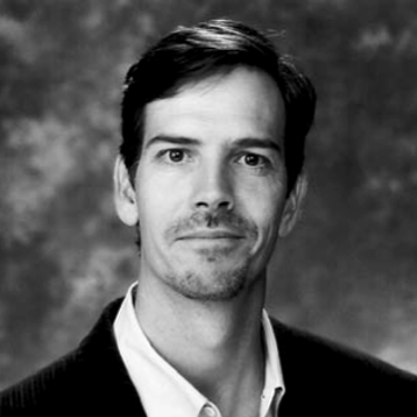 Glenn Williamson, headshot of a man with dark hair and a slight smile.