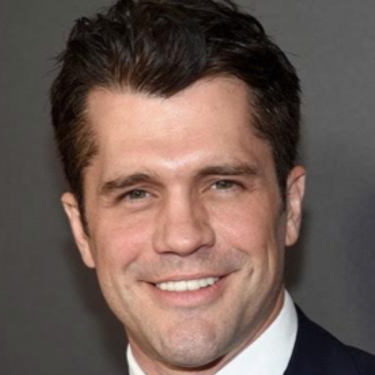 Jeff Wadlow smiling on the red carpet.