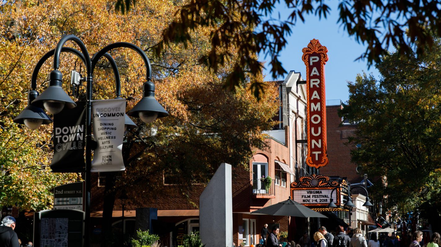 Downtown Charlottesville street view featuring the Paramount Theater and autumn foliage.
