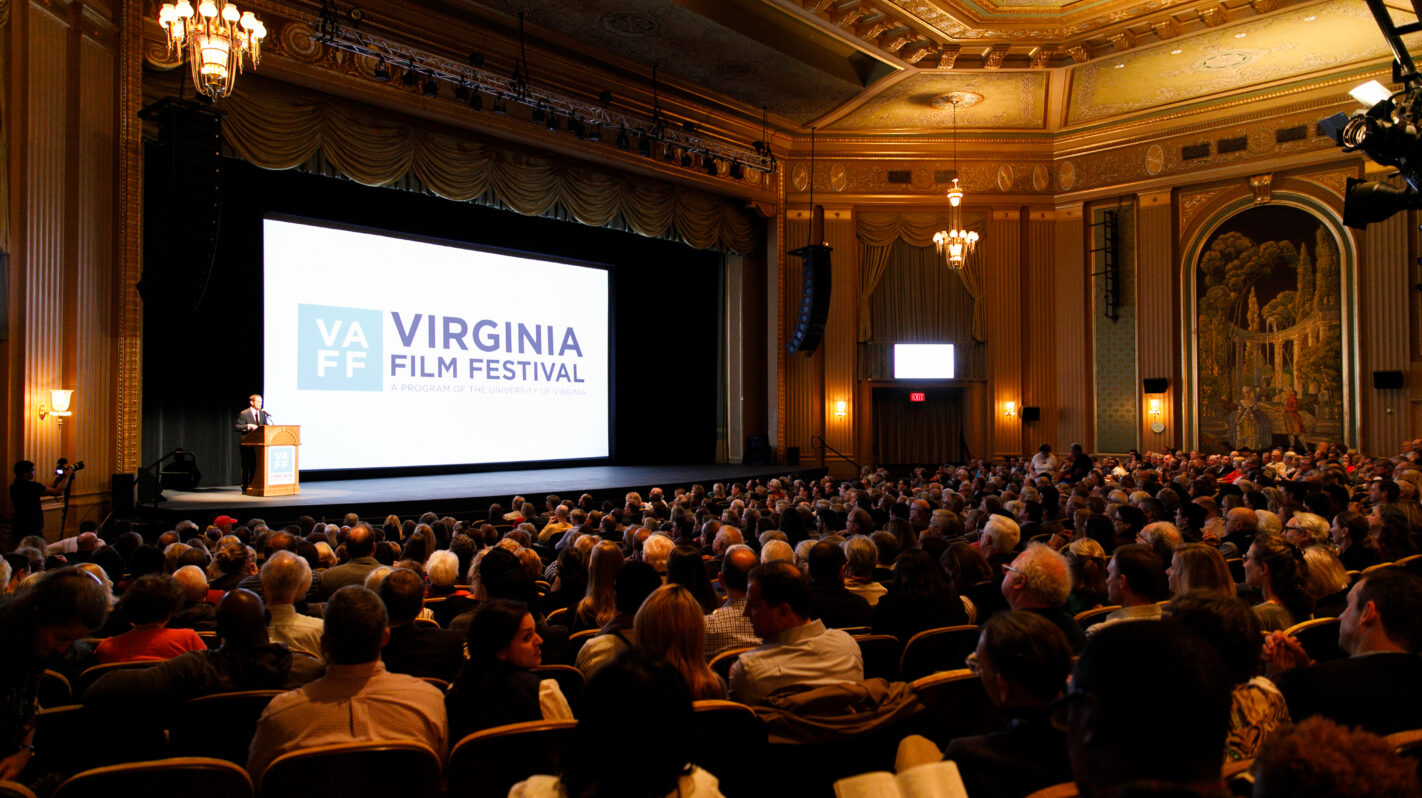 Virginia Film Festival event: Speaker at podium, audience in ornate theater.