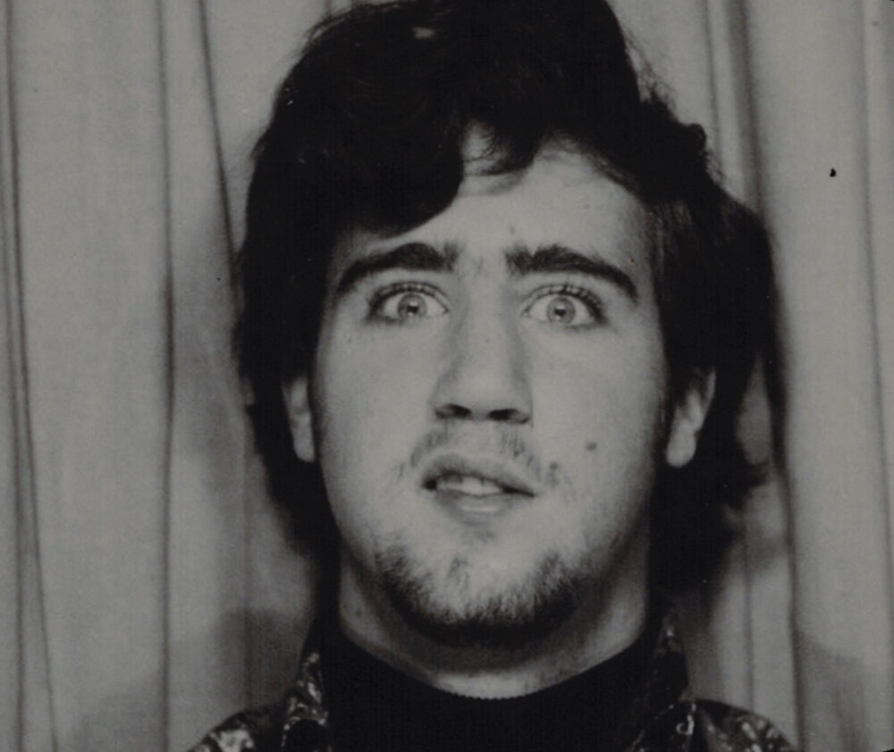 Andy Kaufman with wide eyes and a quirky expression, vintage portrait.