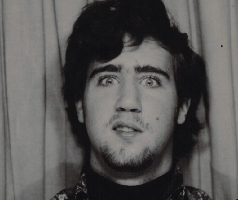 Andy Kaufman with wide eyes and a quirky expression, vintage portrait.