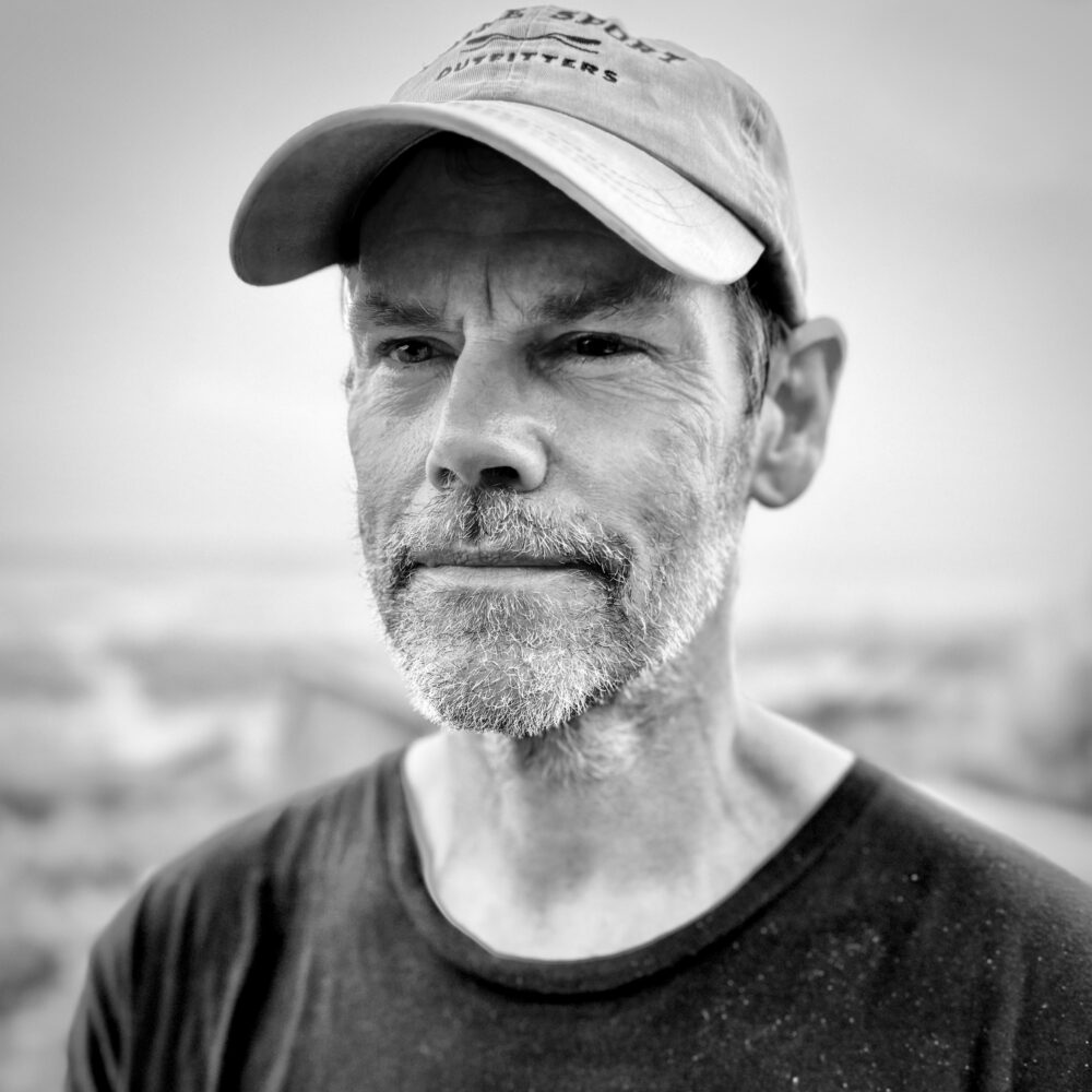 Bill Reifenberger portrait, wearing a cap, with a salt and pepper beard.