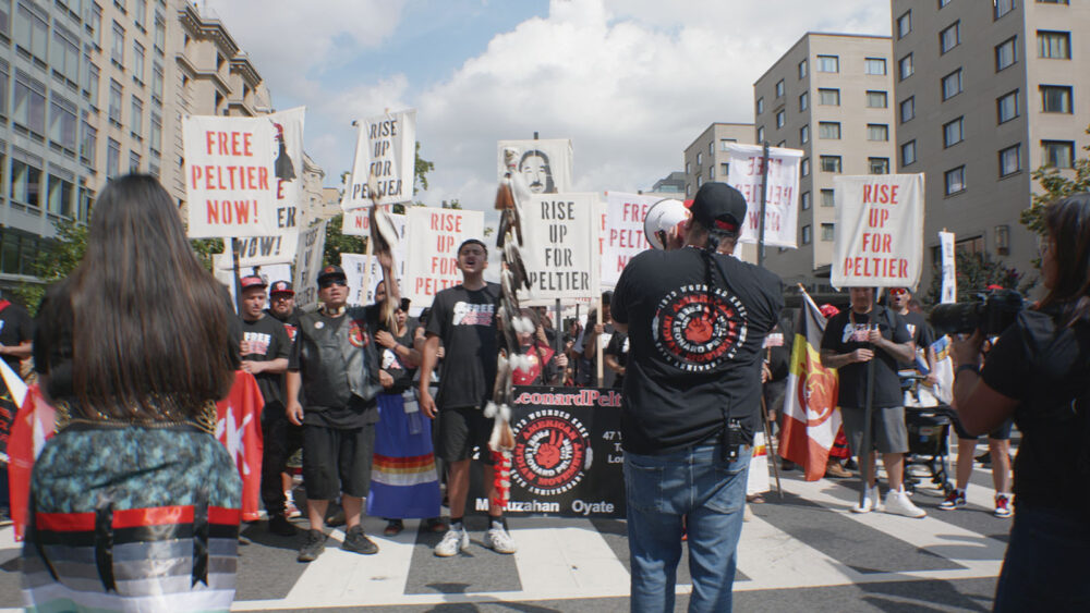Demonstration for Free Leonard Peltier shows protestors holding signs.