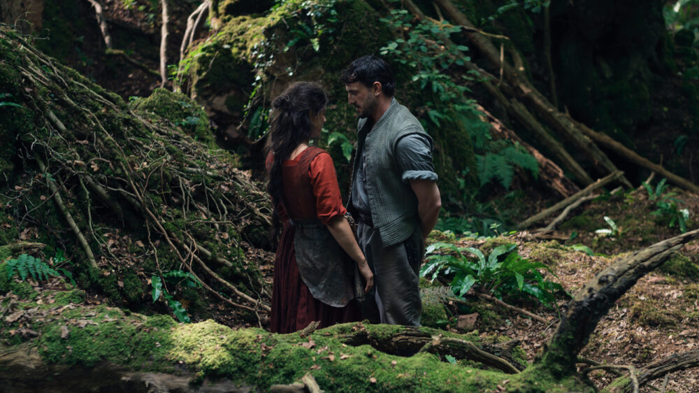 Hamnet movie scene: a man and woman in a forest.