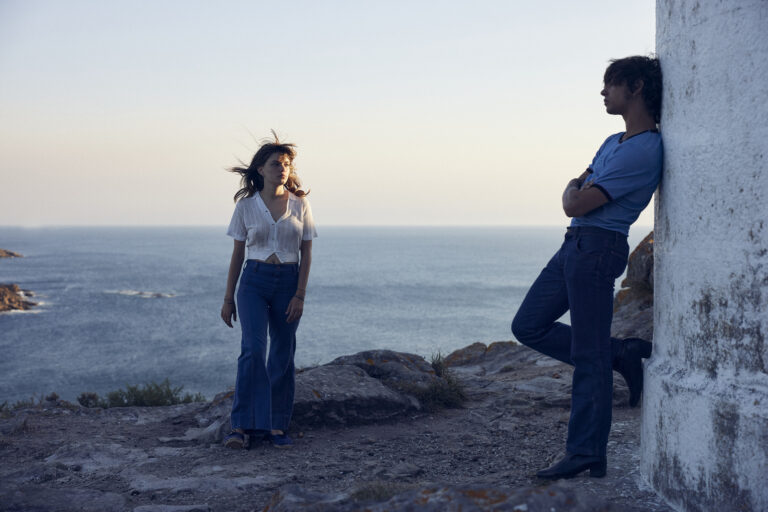 A woman and a man standing by the sea