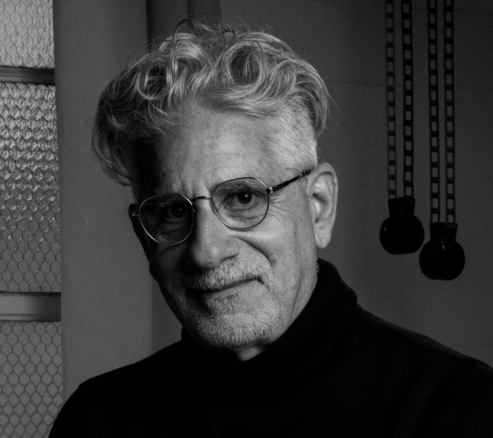Black and white portrait of Rob Spera with glasses and a turtleneck.