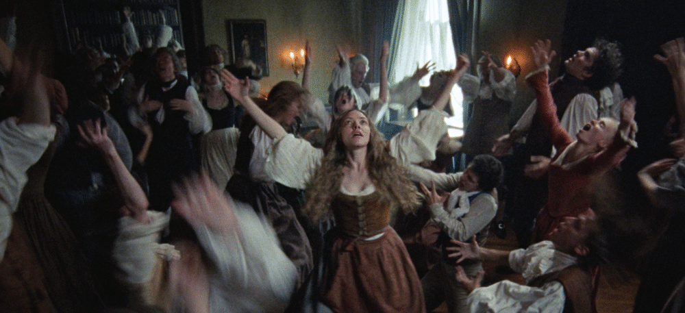 Scene from The Testament of Ann Lee: A group of people with arms raised in worship.