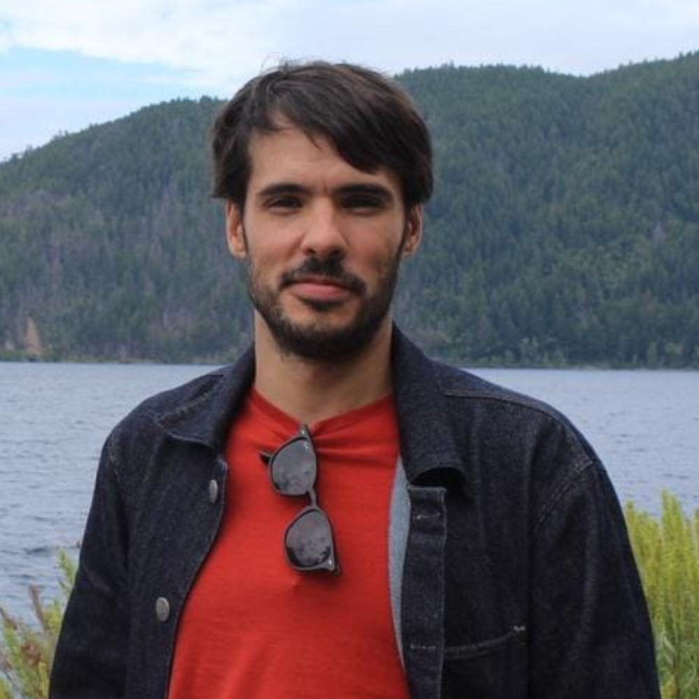 Jesus Fernandez smiling in front of lake.